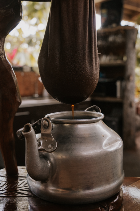 coffee drips from a traditional sock filter into a metal coffee pot on Coffee La Fortuna Costa Rica tours