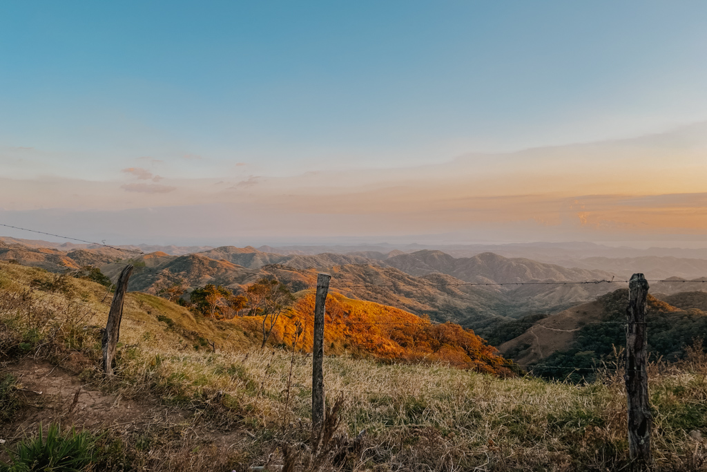 colourful sunset in Monteverde Costa Rica with panoramic views and wooden fence