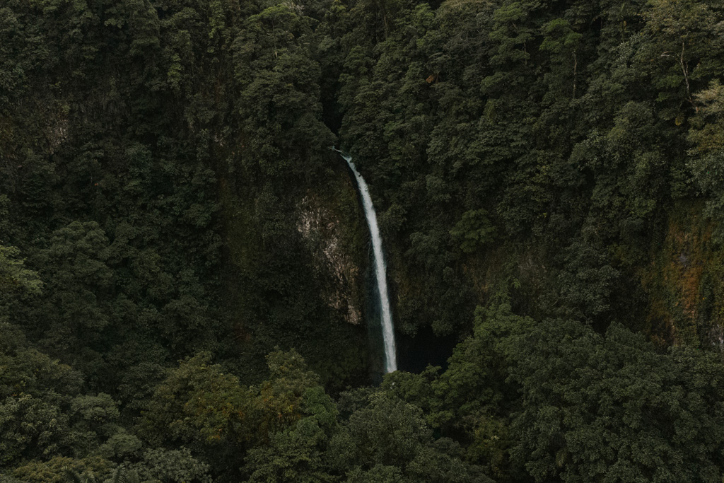 waterfall in the distance in La Fortuna Costa Rica jungle