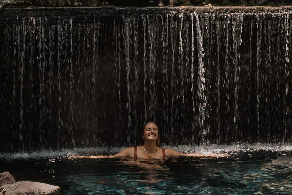 me enjoying the waterfall at ecotermales hot springs in arenal
